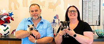 Picture of Executive Director Charles Brown holds Kitten, Bubbles, and Communications and Development Coordinator Caitlin Donnelly holds Puppy, Knox. Both animals are available for adoption.