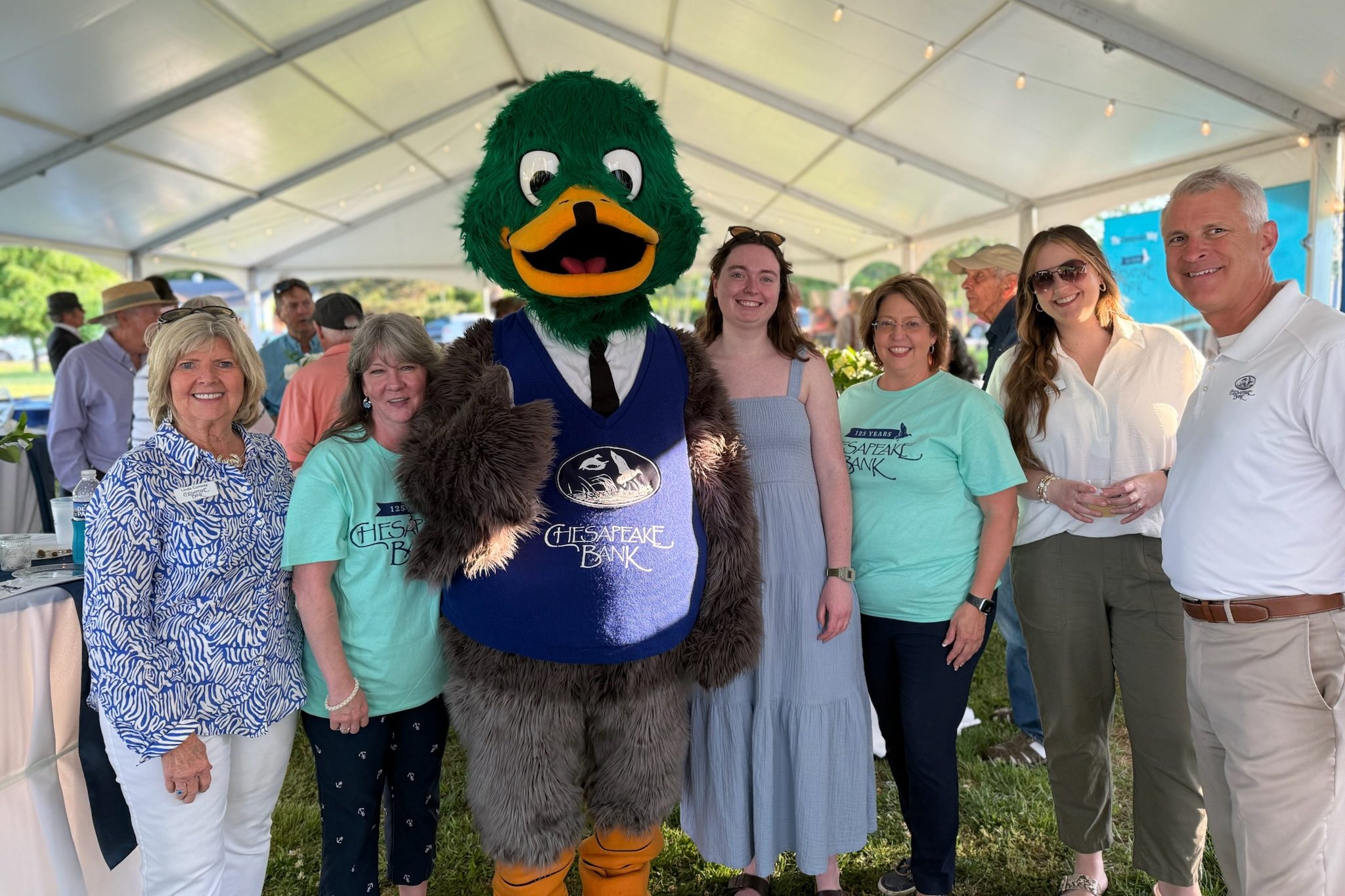 Group of employees with mascot at company event