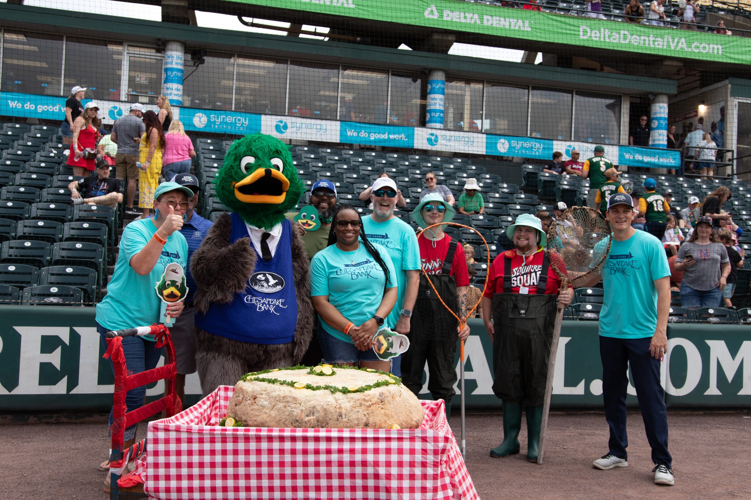 Group of employees showcasing the worlds largest crabcake.