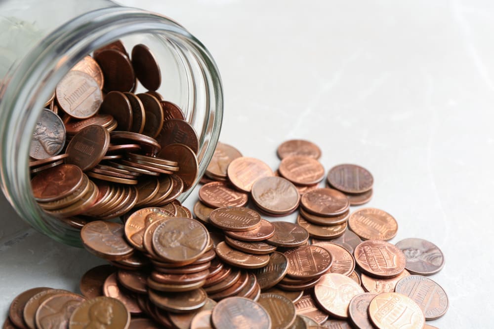 A jar of pennies spilling out, as the U.S. Treasury stops producing new pennies