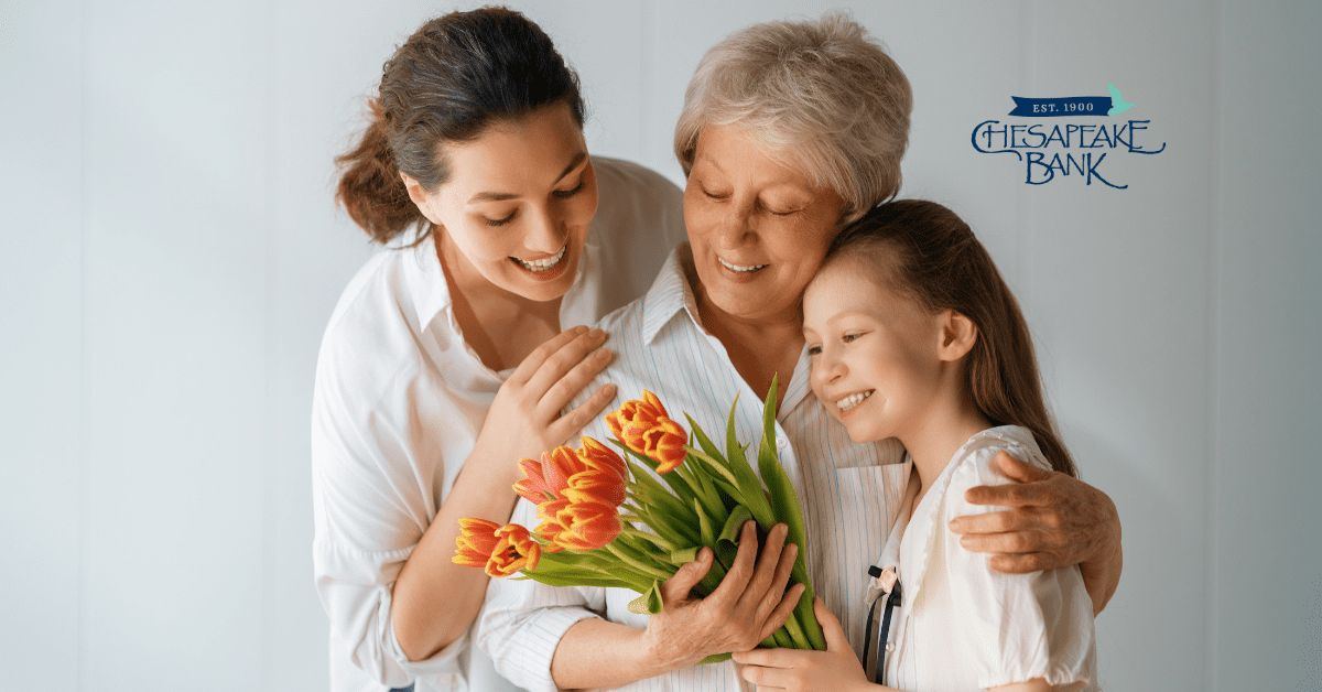 3 generations of women holding flowers